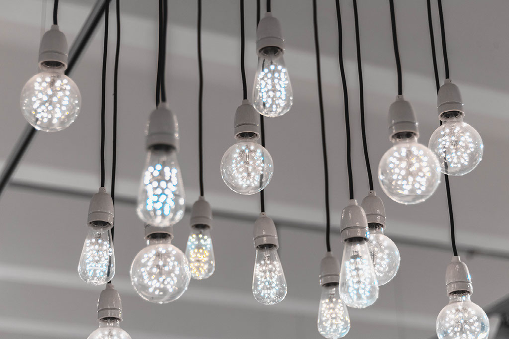 An airy installation of glowing glass pendant lights from the original Elevated Advising website